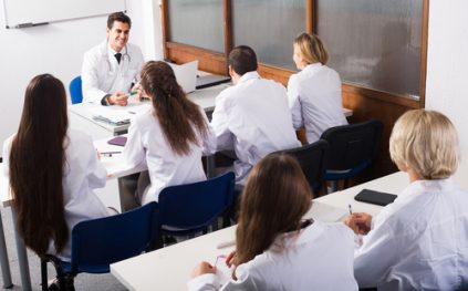 Professor teaches class of medical students.