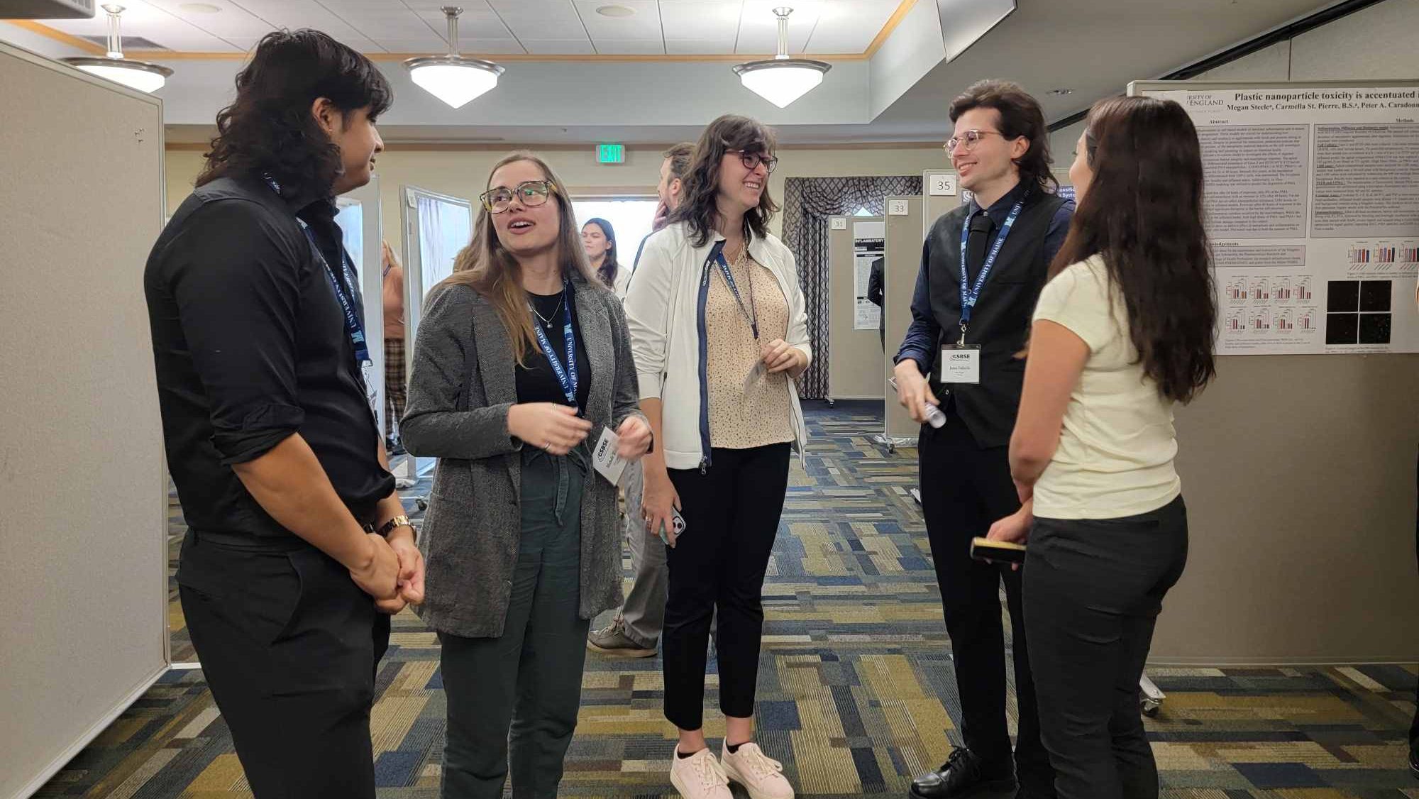 Group of GSBSE students gathered in front of poster displays at the GSBSE 2024 Annual Meeting.